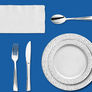 A sparkling silver dinner scene set for honoring heroes and history