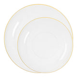 Clear plastic plates with gold detail shown layered for salad and entrée courses at formal dinner