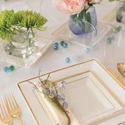 Create a beautiful party atmosphere with the White with Gold Square Edge Rim Plastic Wedding Set and gleaming gold cutlery