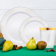 Elegant gold-rimmed vintage plates displayed on a rustic reception table.