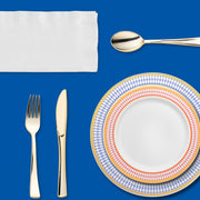 Guests gather around a navy-draped table to enjoy an all-American meal with flair.