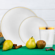 Organic plates with gold rims used at a lavish outdoor reception dinner.