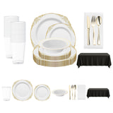 Stylish spring disposable dinnerware set with white and gold plates, gold cutlery, and classic black and white table accents.