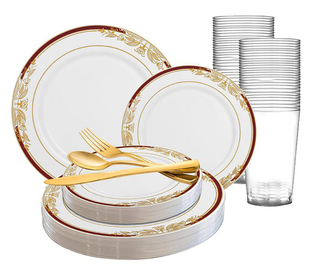 A set of white disposable plates with gold floral patterns on the rims, accompanied by clear plastic cups. The set includes large and small plates, neatly stacked. A gold-colored plastic fork, knife, and spoon are also placed on top of the plates.