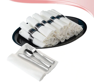 A black tray holds several neatly rolled white napkins secured with black bands. Inset image shows a place setting with white napkin folded around a fork, knife, and spoon. Decorative pink and white gradient swoosh in the corner adds an elegant touch.