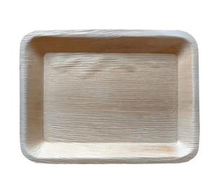 A rectangular disposable tray made from an eco-friendly material, resembling wood or palm leaf. The surface is textured with natural grain patterns, indicating a biodegradable, sustainable product. The tray has raised edges to hold food securely.