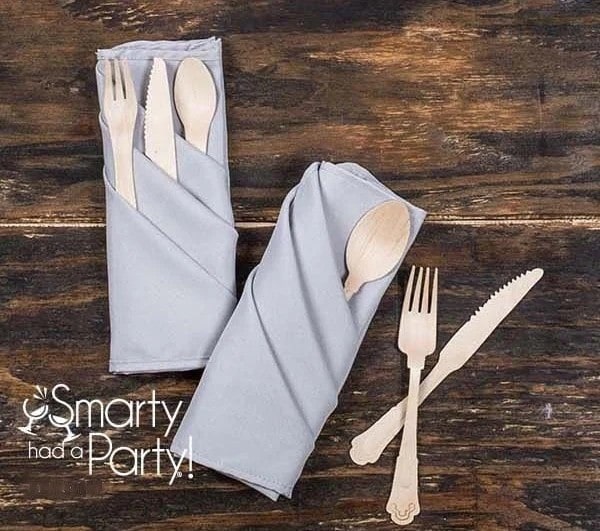 A neatly arranged set of eco-friendly flatware, accompanied by elegant triple pocket napkin fold.