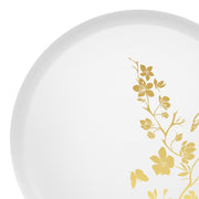 10" white plastic dinner plate with elegant gold floral displayed with plated entrée