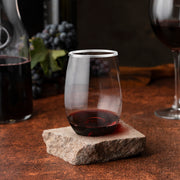 12 oz. Clear Stemless Wine Glasses with silver detail used for white wine at an upscale dinner