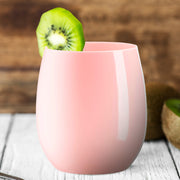 12 oz. Solid Pink Elegant Stemless Plastic Wine Glass accented with a kiwi slice, showcasing its modern curved design