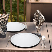 14" clear round trays set on a decorated table for a formal celebration or catered event.