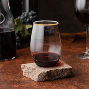 16 oz. Clear with Gold Elegant Stemless Wine Glasses in use, adding sophistication to party drinks