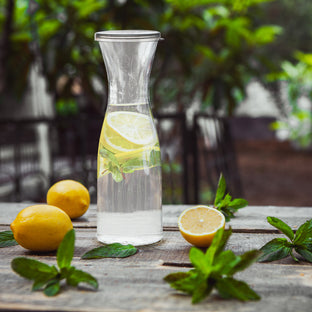 35 oz. Clear Large Disposable Plastic Wine Carafes with Lids offering a refined touch, excellent for upscale food presentation