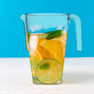 52 oz. Clear Square Plastic Disposable Pitchers used in a lifestyle scene with a classy drink presentation for guests