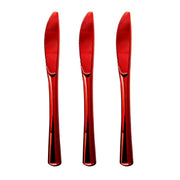 Three identical Shiny Metallic Red Plastic Knives from the Kaya Collection are standing upright side by side. Each BPA-free knife features a sleek design with a smooth handle and a serrated edge, making them perfect for all your disposable cutlery needs.