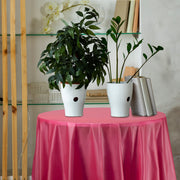 84" round cloths in burgundy dressed tables with elegance and seasonal tone.