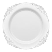 The White with Silver Fancy Round Disposable Plastic Dinner Plates (10.25”) features a round design with an elegant silver floral pattern along the border. The center of the plate is plain, highlighting its sophisticated simplicity. Made from durable plastic, this plate seamlessly blends style and practicality for any occasion.