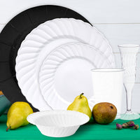 Arrangement of silver cutlery and ivory napkin atop white dinner plate.