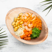 Beautiful outdoor tablescape using Oval Palm Leaf Disposable Bowls to elevate eco-conscious dining with rustic elegance