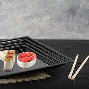 Black Square Serving Trays with groove rims held hors d'oeuvres at an upscale reception.