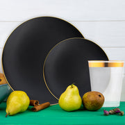 Black and gold dinnerware used to serve entrees at an upscale banquet.