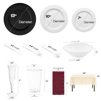 Black chargers framing silver-accented plates for a dramatic yet elegant table presentation.