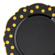 Black disposable plastic dinner plate with a gold dot blossom design