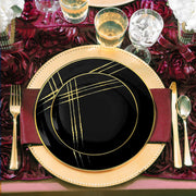 Black disposable salad plates with a round 7.5-inch design and gold brushstroke details, ideal for weddings or parties