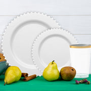Black flatware adds contrast to white plates and rich burgundy accents.