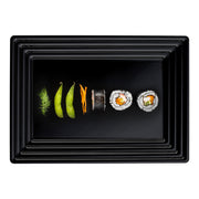 Black rectangular tray with groove rim filled with an assortment of sushi, ideal for catering and upscale events