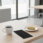 Black velvet paper dinner napkin elegantly placed on a plate, 16 x 16 inches, from a bulk pack of 600