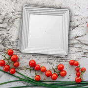 Bulk set includes 8 packs of 3 white square plastic serving trays, totaling 24 trays for catering and large events