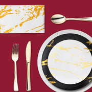Champagne toast setup with gold-rimmed cups and matching flutes.