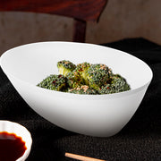 Chic white oval plastic salad bowl with fresh ingredients, modern disposable party supplies for elegant buffet and food presentation.