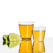 Clear plastic disposable shot glasses with a 1 oz capacity, great for professional and home use