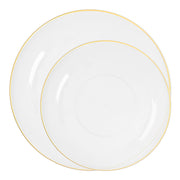 Clear plastic plates with gold detail shown layered for salad and entrée courses at formal dinner