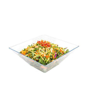 Clear square bowl on a formal dining table, filled with vegetables and dip, designed for stylish food presentation