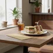 Close-up of ivory paper napkin showcasing soft embossed texture, unfolded to 16 x 16 inches, from 600-count case..