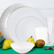Close-up of silver charger plate with white dinner plate and matching silver flatware.