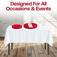 Crisp white tablecloth and napkins balance the bold red plates.