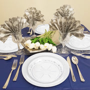 Crystal-clear floral embossed dinner and salad plates displayed on white linen table