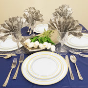 Dinnerware combo styled for festive buffet—includes clear gold plates, cutlery, and plastic tumblers