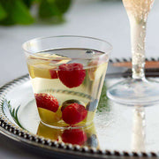 Elegant 5 oz crystal clear plastic cups with a refined design, ideal for weddings and formal gatherings