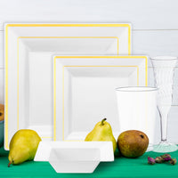 Elegant event table setting featuring white bowls with gold details and luxe accents.