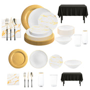 Elegant gold charger plates with matching white and gold dinnerware, perfect for upscale wedding receptions.