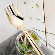 Elegant gold plastic serving forks, 9.75 inches, designed for refined table settings and formal events, case of 60.