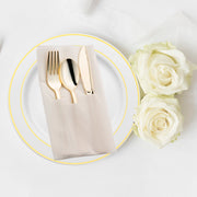 Elegant gold plastic silverware wrapped in a stylish white napkin pocket, designed for upscale dining experiences.
