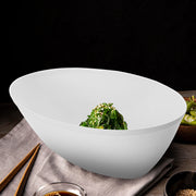 Elegant white oval plastic serving bowl with steamed vegetables, premium disposable dinnerware for formal party catering.