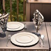 Entrees were served on 10" ivory plates at an event with vintage-style decorations.