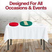 Family table styled with the Feliz Navidad Set and white tablecloths for Christmas celebrations.